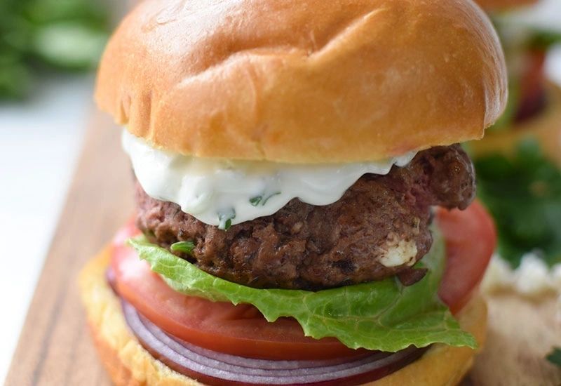 Juicy smash burger with fresh toppings at Sunset Grill OKI in Oak Island