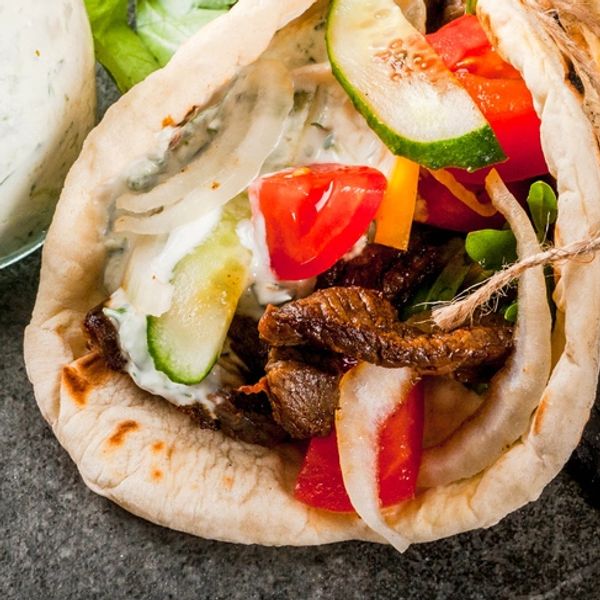 Authentic Mediterranean gyro with fresh vegetables at Sunset Grill OKI